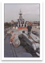 Cropped photo of a family visiting a battleship, straightened and extracted from the scan