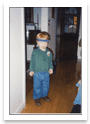 Cropped photo of a child standing in a hallway, straightened and extracted from the scan
